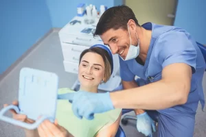 dentist showing patient information on tablet