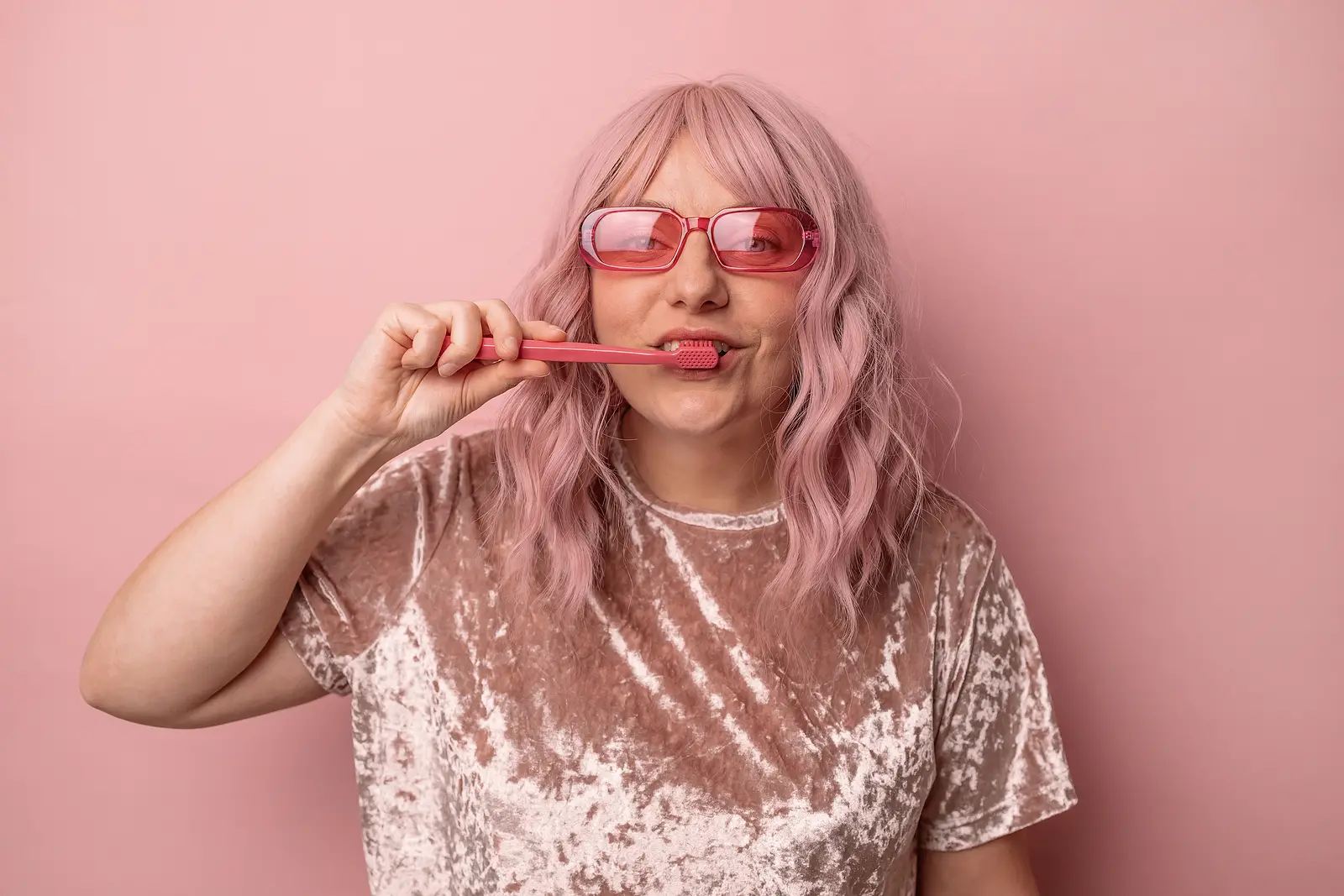happy smiling woman brushing teeth