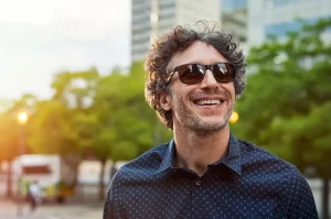 man smiling looking up at the sky