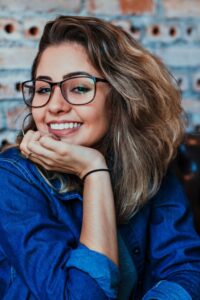 woman smiling resting chin on hand