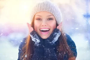 young woman in snow smiling